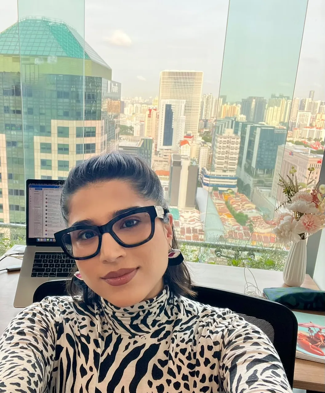 Shubham at her desk in Singapore