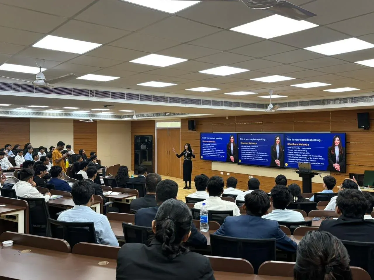 Shubham teaching a full lecture hall